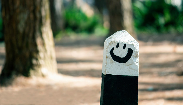 The smile kilo pillar​ near road in pine forest at Chiang Mai, Thailand. 