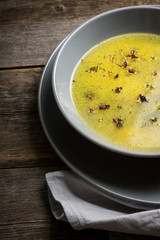 Hot pea soup with spices on the rustic background. Selective focus. Shallow depth of field.