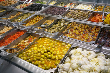 variety of colorful fresh vegetable salad in container in restaurant