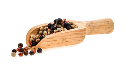 dried peppers seed in wood scoop on white background