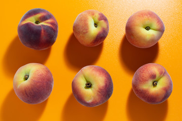 juicy fresh ripe peach on orange matte background