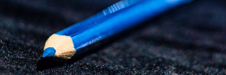 Macro background with blue pencil