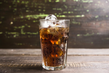 Refreshing cold cherry cola on the wooden background. Selective focus.