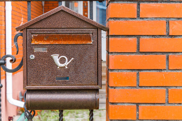 A beautiful mailbox hangs waiting for newspapers, parcels and letters.