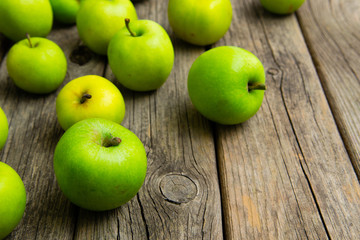 green apples on old wooden background