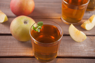 Apple juice and apples on wooden table. Selective focus