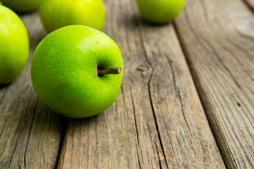 green apples on old wooden background