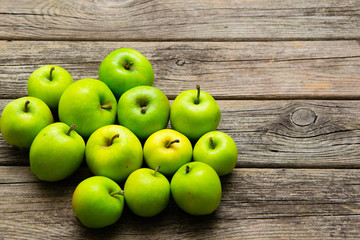 green apples on old wooden background
