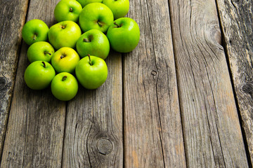 green apples on old wooden background