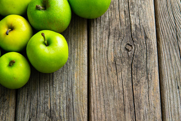 green apples on old wooden background