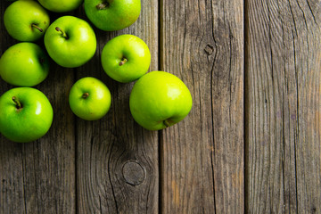 green apples on old wooden background