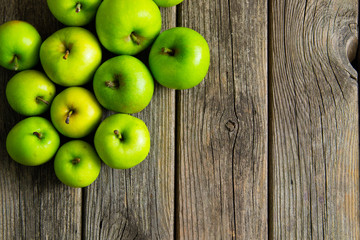 green apples on old wooden background