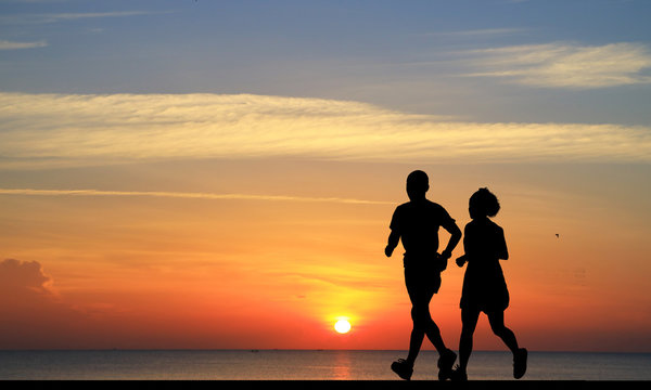 silhouette couple lover  running on blurry sunset