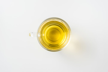 Top view of glass cup of hot tea on white background