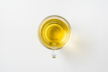 Top view of glass cup of hot tea on white background