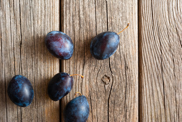 plums on old wood table directly above