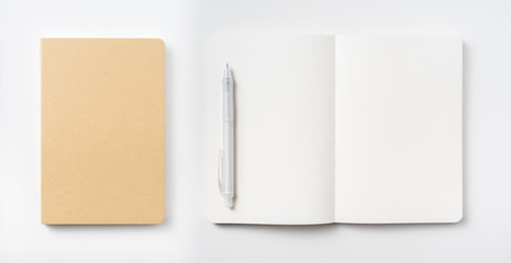 Top view of hardcover kraft notebook and pen