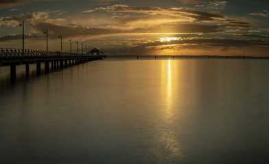 Fototapeta na wymiar Panoramic Pier Sunrise with Beautiful Sky