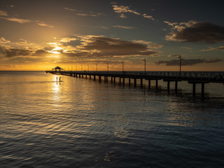 Fototapeta na wymiar Pier Sunrise with Beautiful Sky