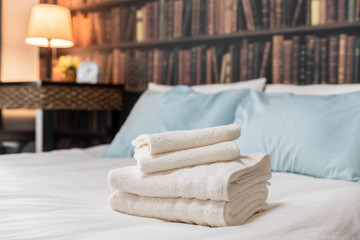 Fototapeta na wymiar Clean white towels folded on the bed