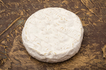 Camembert cheese on a textural table. Snack to wine. closeup