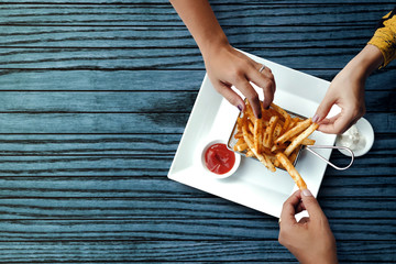 Three Friends Eating French Potato Fries, Serve on Metal Mesh Flying Sieve with Two Dipping Sauce....
