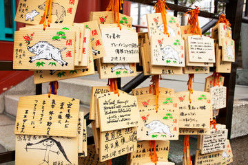 Ema wood tag or wooden label for people write their prayers and leave hang up at Marishiten Tokudaiji Temple in Ameyoko Market at Ueno city in Tokyo, Japan