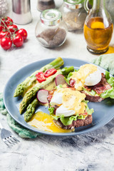 Sandwiches with bacon, poached egg and asparagus