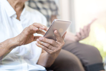 Happy elderly senior people society lifestyle technology concept. Ageing Asia women using tablet...