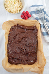 Closeup of chocolate cake with raspberry and streusel on a table