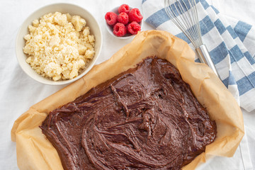 Closeup of chocolate cake with raspberry and streusel on a table