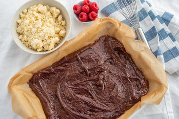 Closeup of chocolate cake with raspberry and streusel on a table