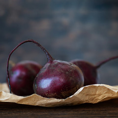 Fresh organic beets, Beets in blurring at low depth of field. Dark rustic wood background. Copy space.