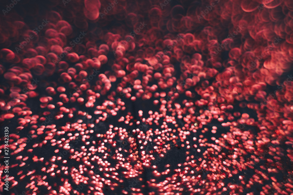 Poster Beautiful red bokeh on a dark abstract background.