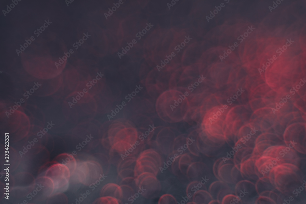 Poster Beautiful red bokeh on a dark abstract background.