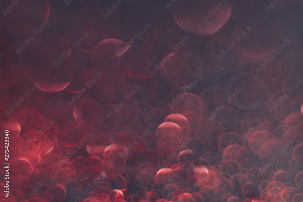 Poster beautiful red bokeh on a dark abstract background.