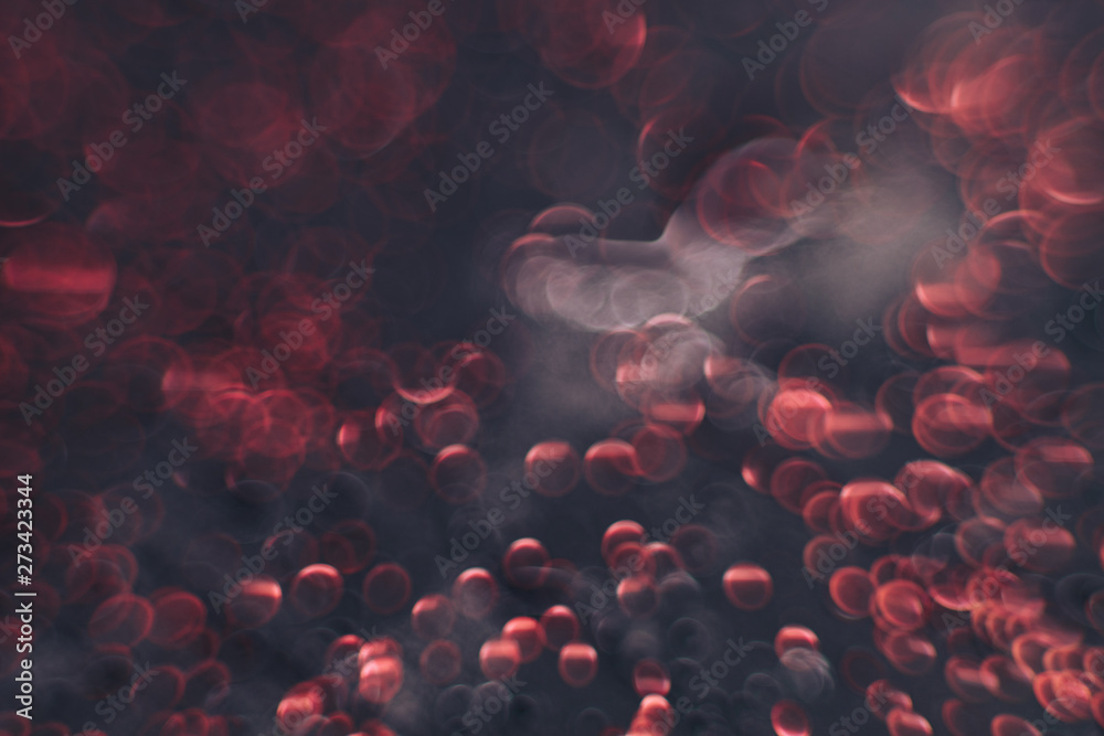 Poster beautiful red bokeh on a dark abstract background.