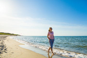 Woman waking on beach