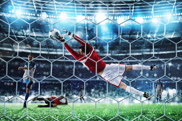 Goalkeeper catches the ball in the stadium during a football game.
