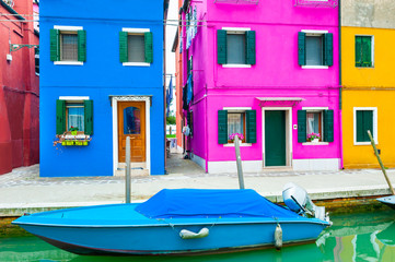 Fototapeta na wymiar Colorful houses on the canal in Burano island, Venice, Italy. Famous travel destination