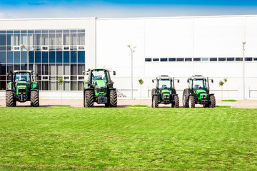 new tractors are standing next to the trading pavilion for sale in Kiev region, Ukraine.