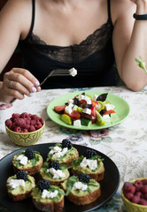 A gourmet lunch: guacamole sandwiches, raspberries and a greek salad.