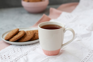 A tasty snack: a cup of tea and a plate of cookies.