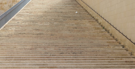 broad stairway made from beige rock