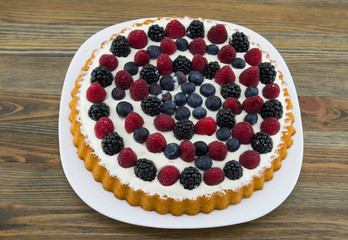 Dessert with fruits and mascarpone, fresh fruits, raspberries, blackberries and blueberries. Summer or spring light dessert in Italian style.
