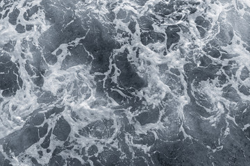 Beautiful foamy dark sea water surface. Horizontal color photography.