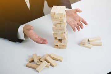 .Planning risk and strategy in businessman gambling placing wooden block.Business concept for...