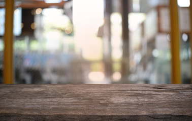 Empty dark wooden table in front of abstract blurred bokeh background of restaurant . can be used for display or montage your products.Mock up for space.