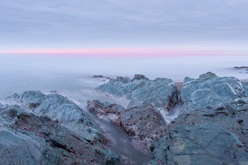 A beautiful scenery of wave splashing at the sunrise.