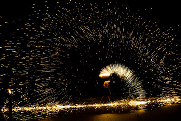 THAILAND - APRIL 08, 2019: Beautiful Fire Show in night on the Beach, Lively night with dancing amazing fire show, Koh Samed island in Thailand